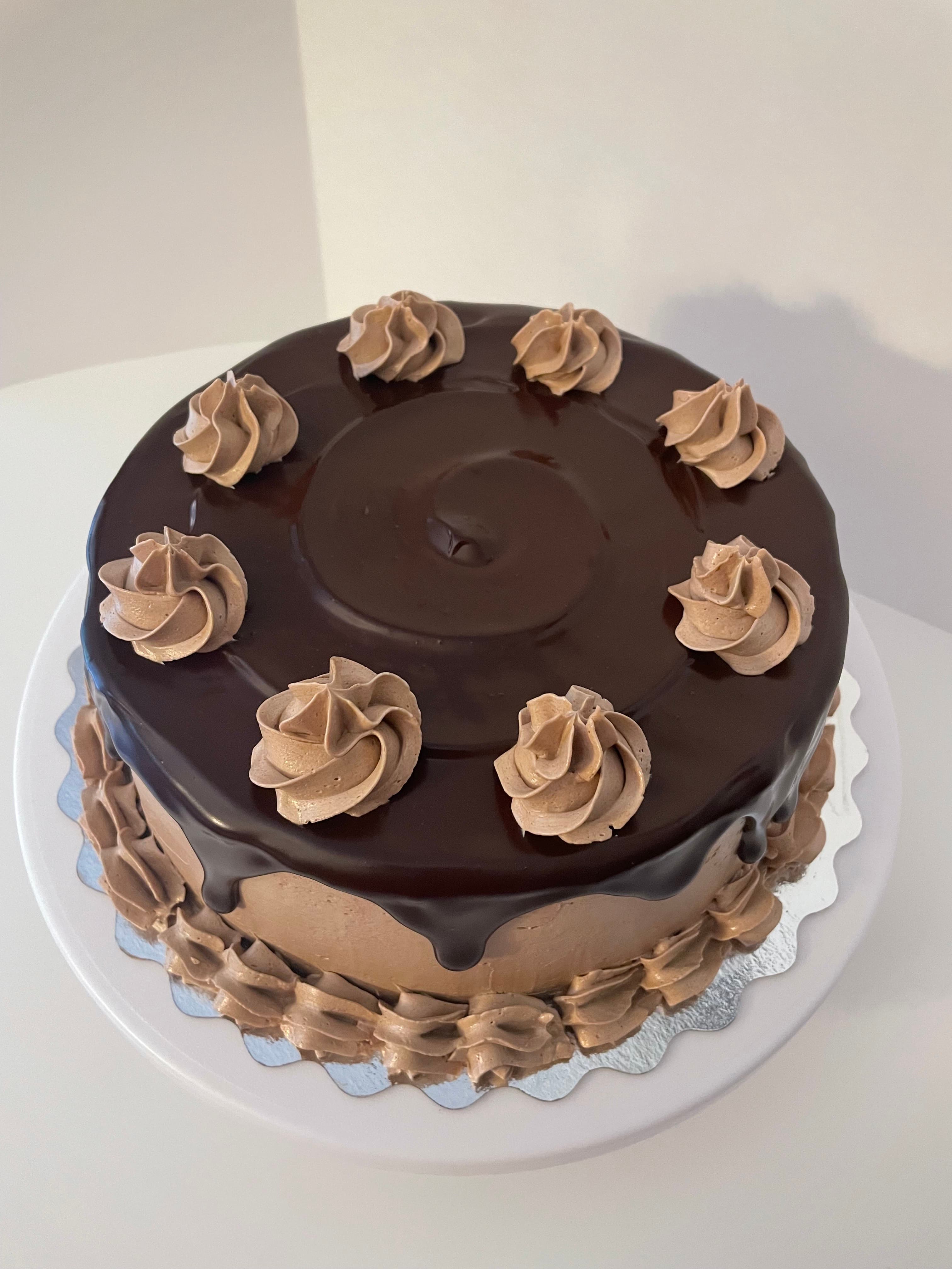 Top view of a death by chocolate cake with chocolate frosting and piped rosettes